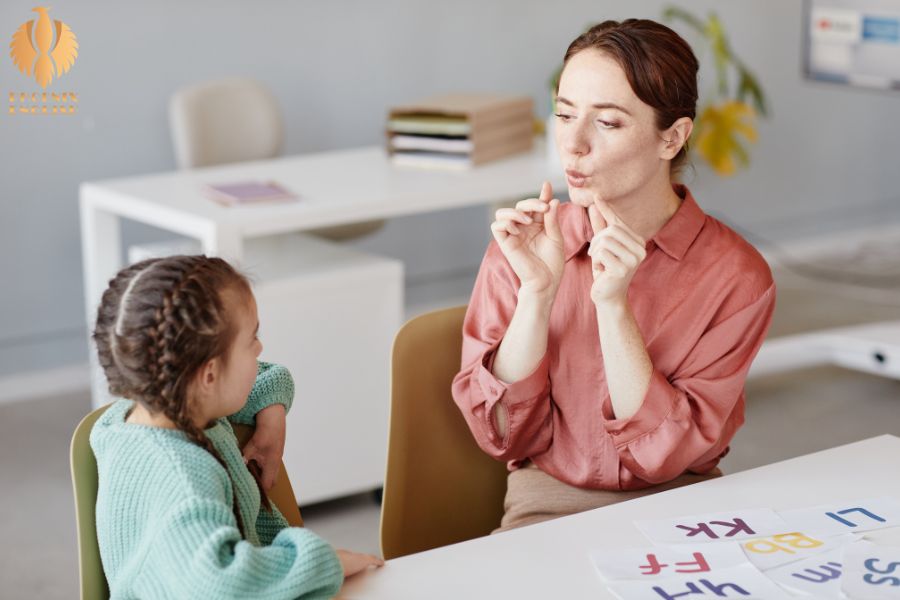 an image about A mother teaching her daughter to pronounce a word