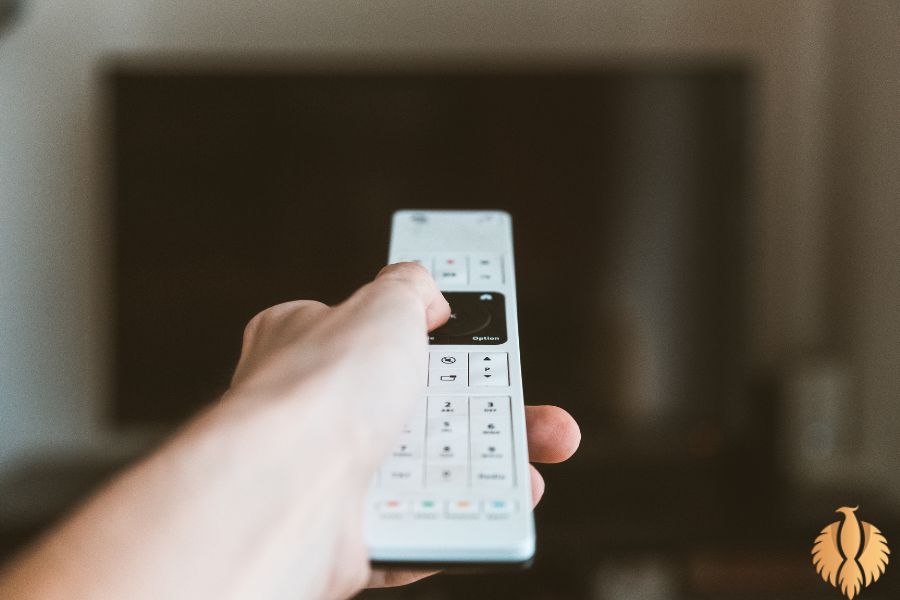 a pic about a man is using a remote for tv